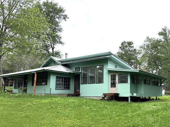 Side of the house showing the studio and enclosed porch.