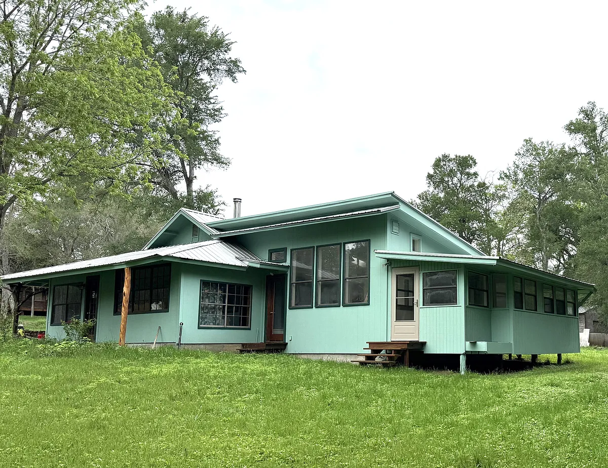 Side of the house showing the studio and enclosed porch. - S Webberwood Way