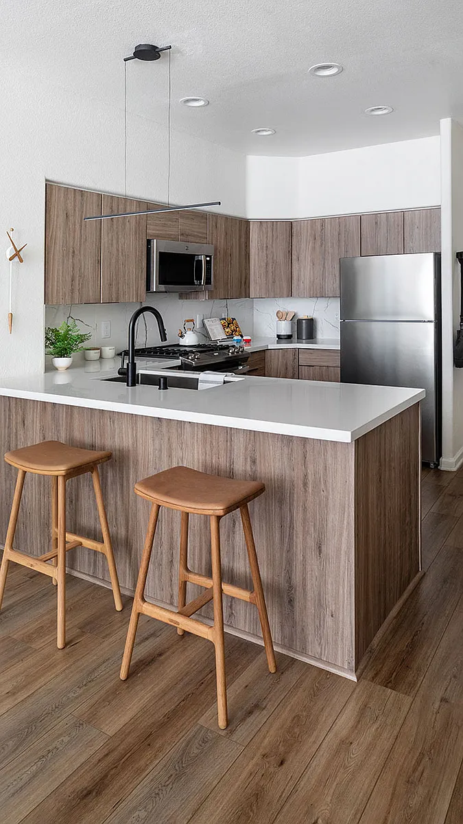 Apartment Kitchen with Stainless Steel Appliances, quartz counters and wood floors. - Griffis Mission Valley