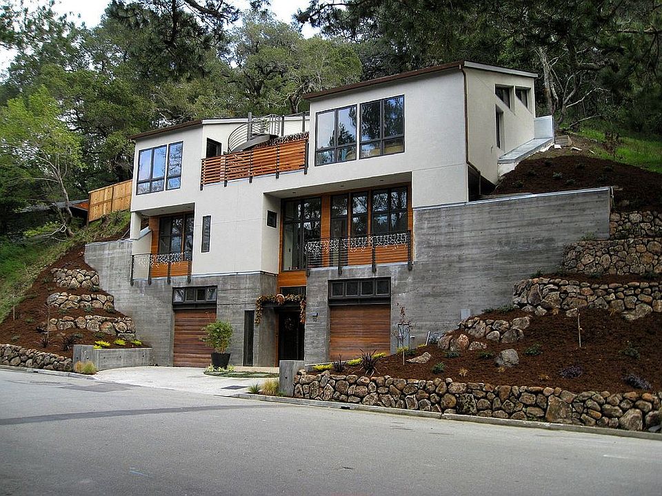 Exterior from Glen Drive, showing cedar siding, landscaping
