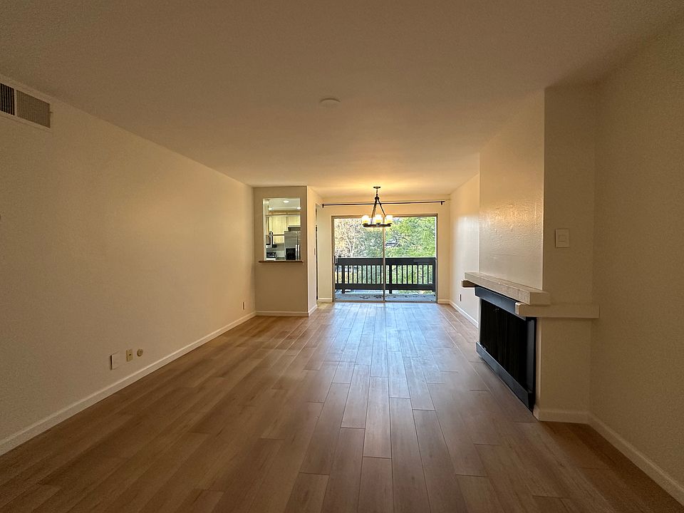 Living room and dining area with lots of natural light and treetop view!