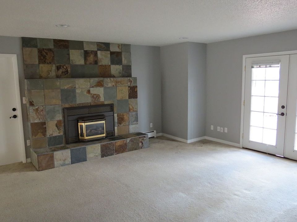 Slate fireplace with fireplace insert.