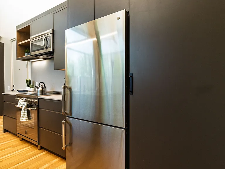 Open concept kitchen with seating for 4 at the kitchen island. The kitchen is fully stocked and ready to use.