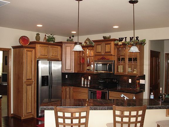 Kitchen with granite tile counters, eating bar and pantry.