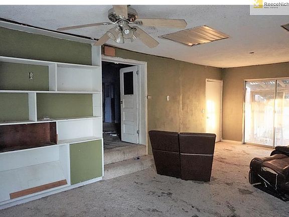 Great room with built ins and patio slider door to back yard covered patio.