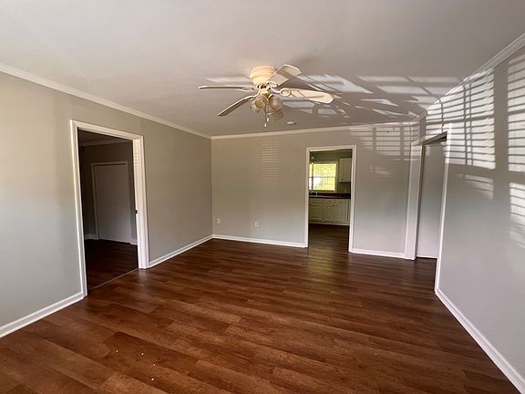 Front living area facing the kitchen, Master bedroom on the left, bathroom and other bedrooms to the right