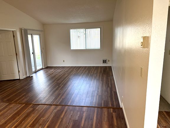LIVING ROOM WITH SLIDING GLASS DOOR. SIDE ROOM BEDROOM OR DEN AREA.