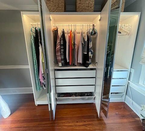 Wall wardrobe with built-in drawers. Shoe drawer on bottom. Lights turn on when doors open.