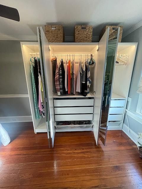 Wall wardrobe with built-in drawers. Shoe drawer on bottom. Lights turn on when doors open.