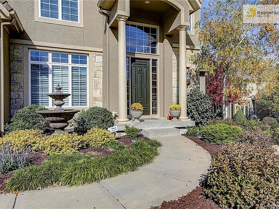 Inviting front entry with fountain and beautiful landscape.