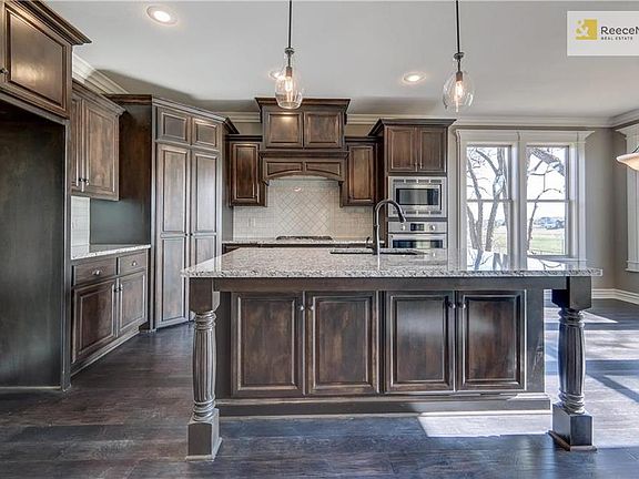 Designer chefs kitchen includes black silgranite or stainless double bowl sink with designer Kohler faucet with sprayer. Choice of custom wood or stainless steel exhaust hood.