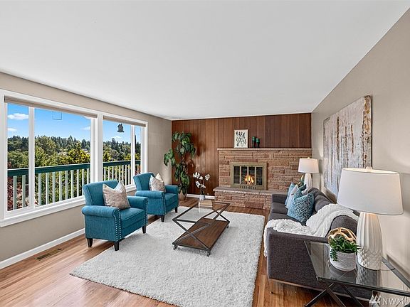 Perched to enhance the Panoramic Territorial & Mount Rainier Views, the Light Filled Great Room has a wall off windows revealing