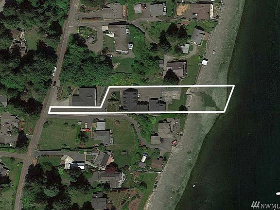 The aerial view highlights the lot which has a private driveway to the residence.  There is also a buoy in the tidelands - perfect for docking your boat.