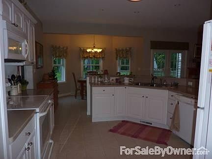 Kitchen
						:
						From the dining room. Eat-in area beyond the cabinets.