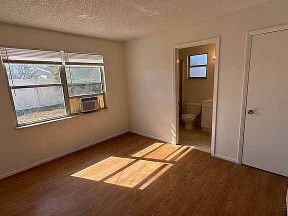 Primary bedroom with attached full bathroom and closet