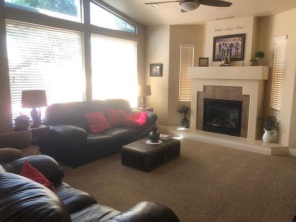 Large family room with cozy gas fireplace & access to private backyard.