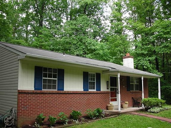 Brick Front Ranch Surrounded by lush mature trees