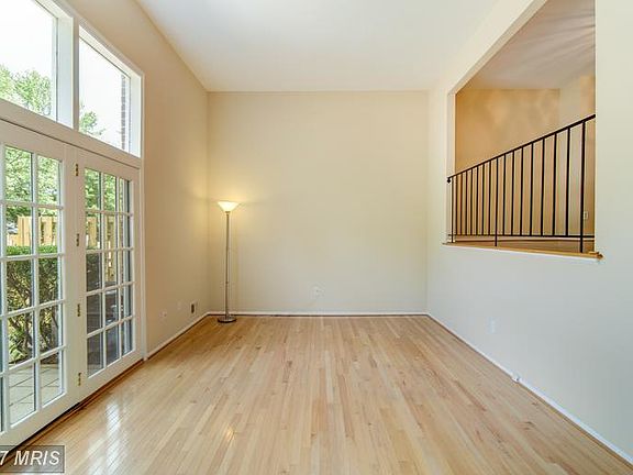 Light filled living room leads to fenced patio