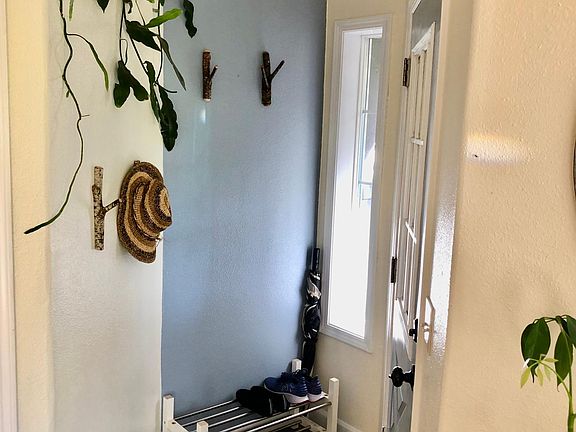 Front door, coat closet, handmade coat hooks on the wall
