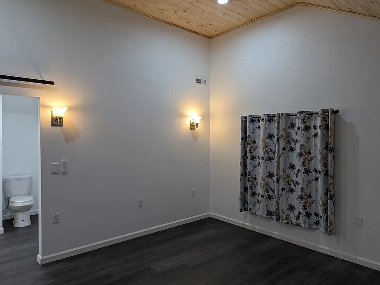 Light sconces and ceiling fan with light above.