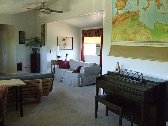 Spacious family room with vaulted ceilings and newer carpeting