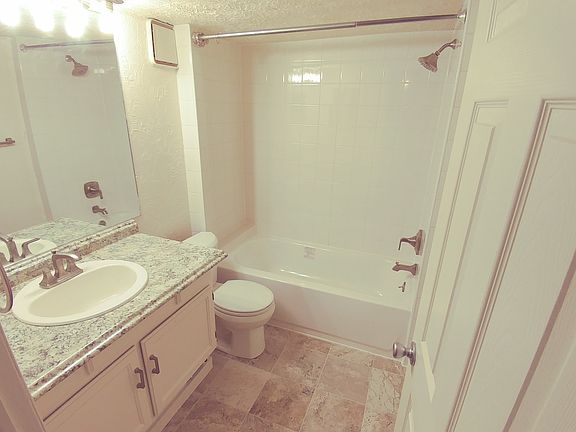 bath- new tile floors, tub surround, counter, sink, premium