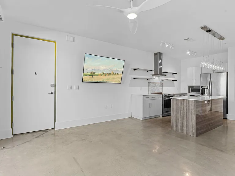 The living room is large and comes with a 65" HD TV.