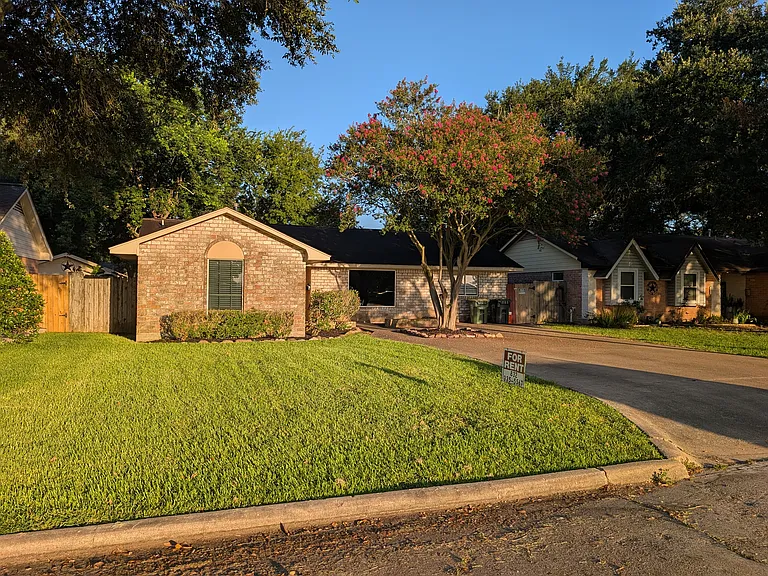 Street View with a view of the oversize driveway that will accommodate four cars.