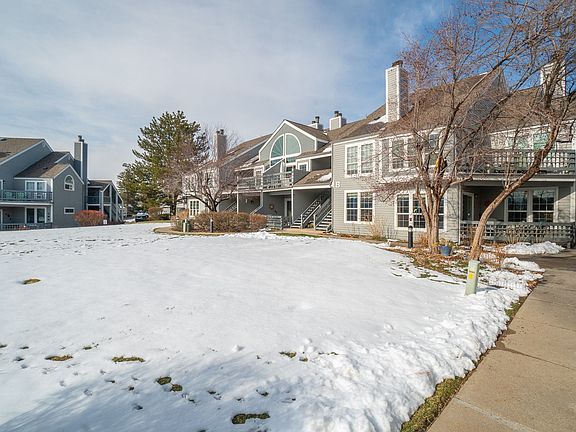 side facing view of porch (upstairs, in the middle) and stairs entrance to condo