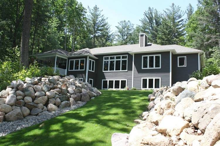 Custom Built Executive Home on Sanford Lake with over 125 feet frontage and a lovely view from every room in the house! Old world quality with exquisite Amish custom built maple cabinetry, 5" baseboard, 4.6" trim, handmade columns & crown molding. Maple flooring. Stunning kitchen with oversized granite island, professional grade refrigerator/range, walk-in pantry. High-end stone lighting in main living areas. Large breakfast area with access to 16x16 covered deck overlooking the lake. Living Room features custom built-ins & Cozy Heat Woodburning Fireplace. Beautiful open floor plan. Main Floor master suite featuring custom woodwork, granite, Jacuzzi. Main floor laundry & office/guest bedroom with attached bath. Additional 1800 sq.ft. finished in lower level inc. 2 family room areas-24x17 each & 2 bedrooms with daylight windows, full bath, & 800 sq.ft of unfin. storage area. Top energy efficiency inc zoned in-floor heating inc garage, Lochinvar boiler,energy truss/spray foam ins. More!