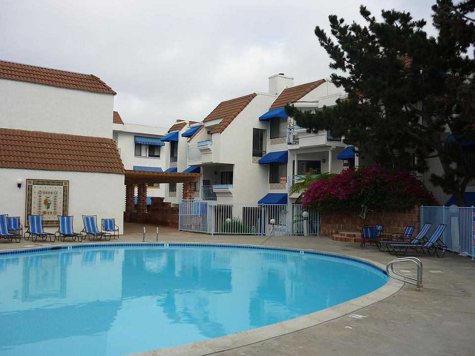 Looking across the pool at the unit. Do you see the orange "For Rent" sign?