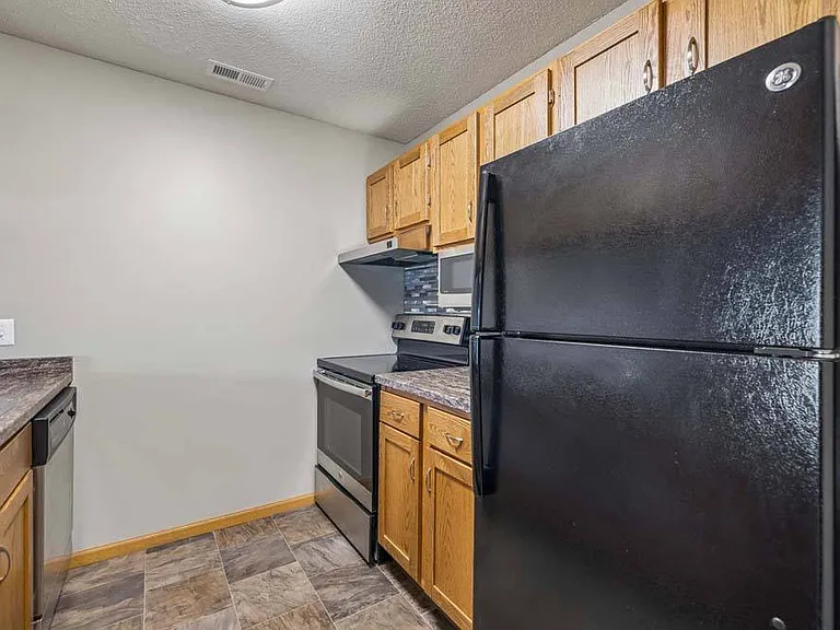 A thoughtfully designed kitchen with generous cabinet space and a functional layout keeps everything within easy reach.