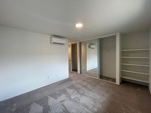 Master Bedroom with his & her closets plus great open shelving area
