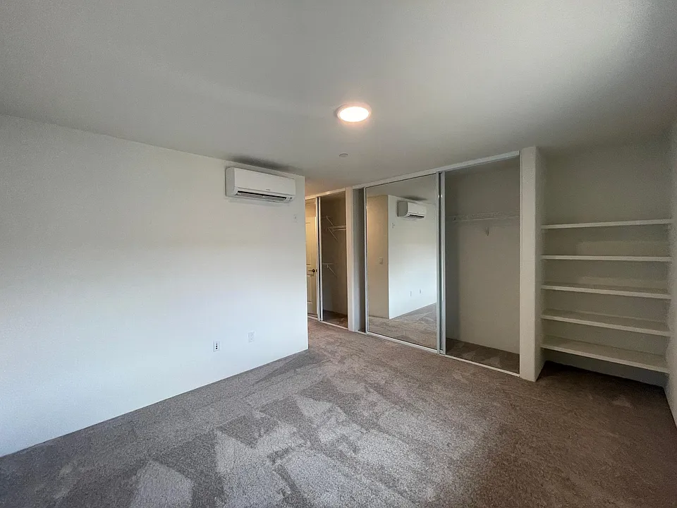 Master Bedroom with his & her closets plus great open shelving area