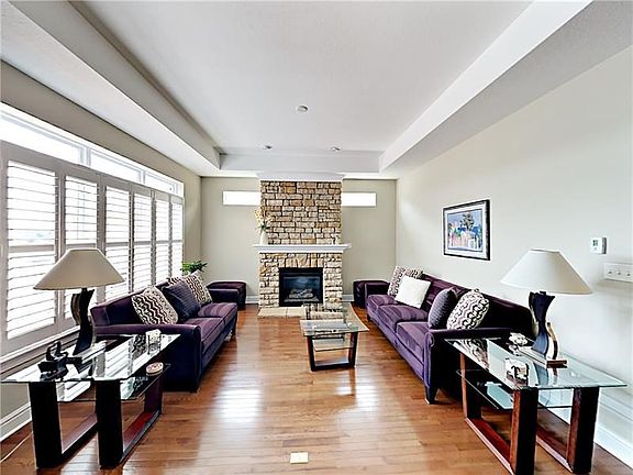 The beautiful stone fireplace makes a wonderful focal point in the light and bright living room.