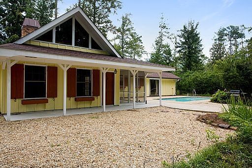 Acadian cottage situated on 2.66 acres.