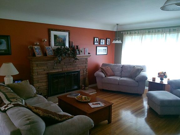 Formal living room with hardwood floors.  Lovely brick fireplace with custom built mantle.  Huge picture windows allow for ample natural lighting to stream in throughout the day.  Quaint coffered ceilings, updated light fixtures and designer paint choices pinpoint the quality in the remodel and updated here.