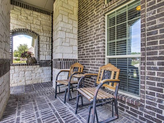 This covered front porch faces east and is perfect for morning coffee!