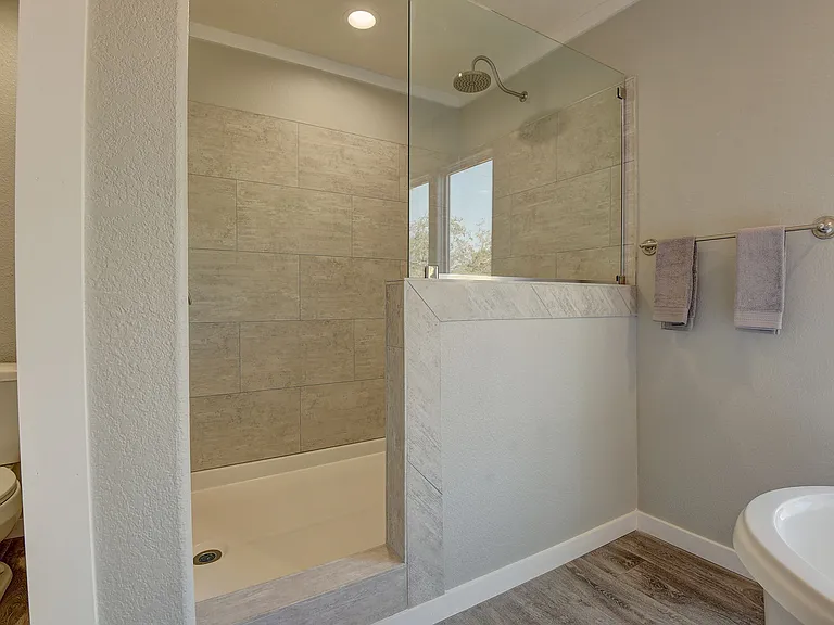 Spa-inspired walk-in shower with sleek tile surround and glass enclosure_offering a clean, modern retreat feel.