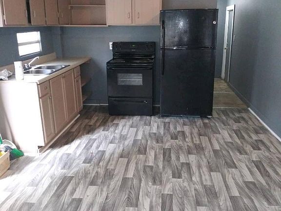 Living room and kitchen area. New flooring.