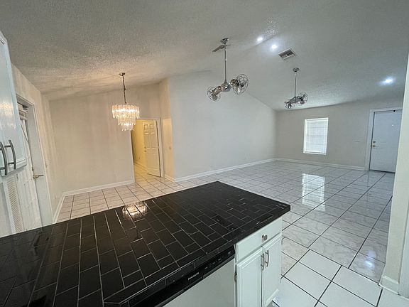 View from the kitchen. View of the main entrance door to the right, the living room and the dining area.