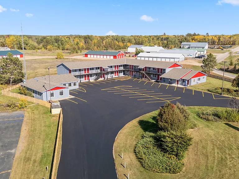 Bird's-eye view showcasing the community, ample parking, and convenient location.