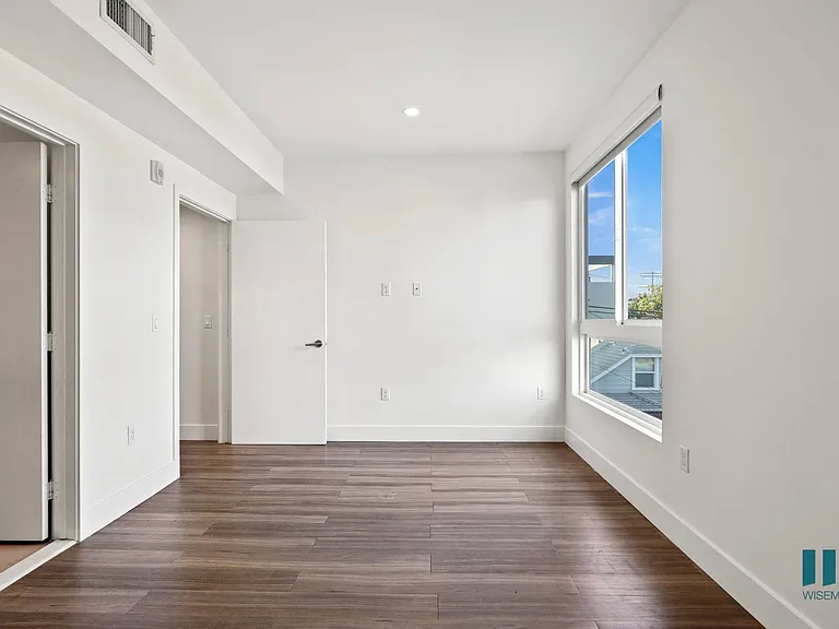 Bedroom with Vinyl Flooring, Bathroom, and Large Windows