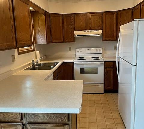 Kitchen area also includes a built in dishwasher and additional open floor space.