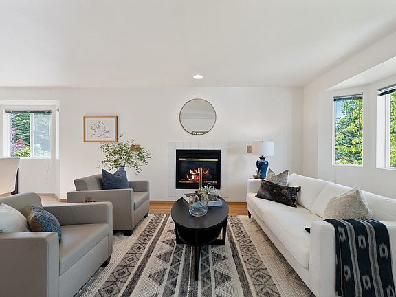 The living room is inviting with a gas fireplace that includes a blower for an additional heat source.