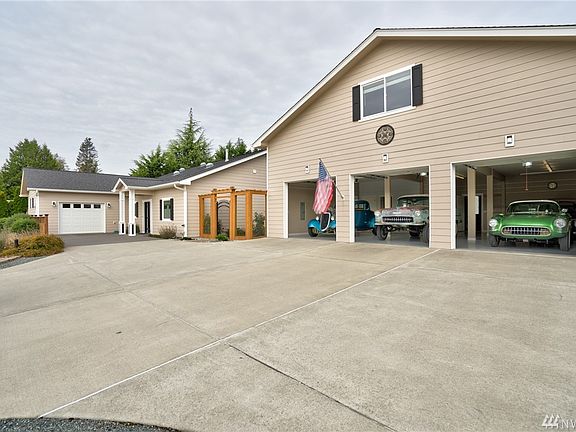Some homes say car buffs are welcome. This home say that on steroids. Not only is there the attached over sized one car garage, this photo demonstrates the potential to house 3 cars, plus a double stack behind the green corvette. You want more? Well we have it too. Around the corner, attached this this garage is what e call the wash room. This vehicle storage garage is perfect for over flow or for special shop projects. Easily fits 2 plus vehicles.
