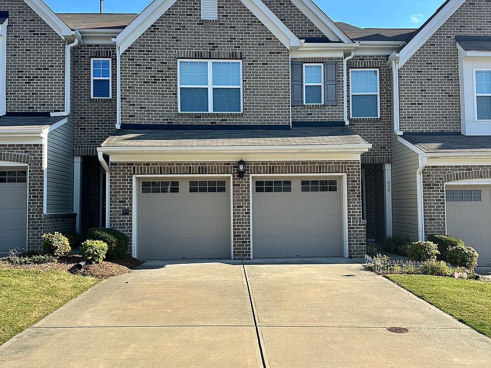 Front view with wide driveway