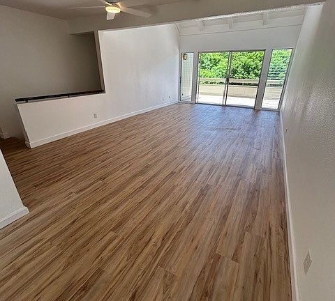 Large Living room with vinyl planking installed in 2023 looking out to ample sized deck