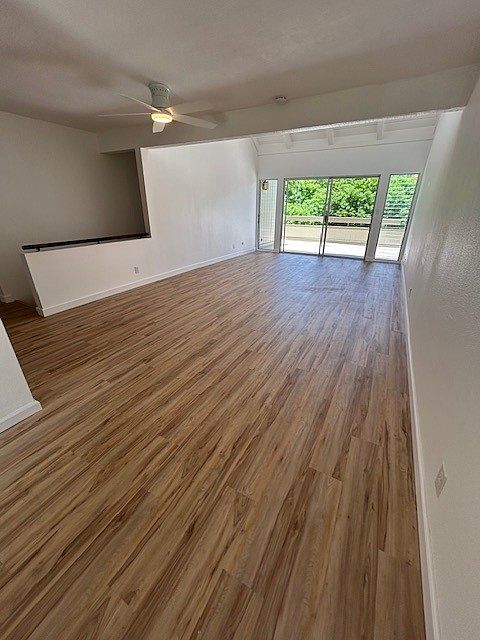 Large Living room with vinyl planking installed in 2023 looking out to ample sized deck