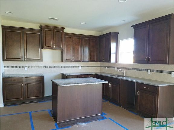 No shortage of cabinets in this kitchen. Granite countertops plus a ceramic tile backsplash ... ver